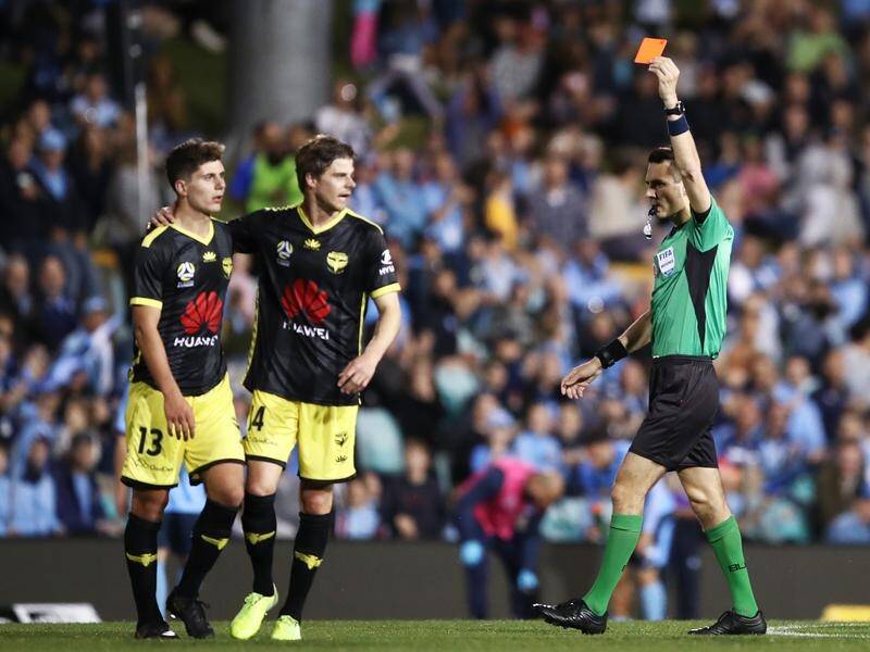 Referee Jonathan Barreiro shows Phoenix's Liberato Cacace (#13) a red card.