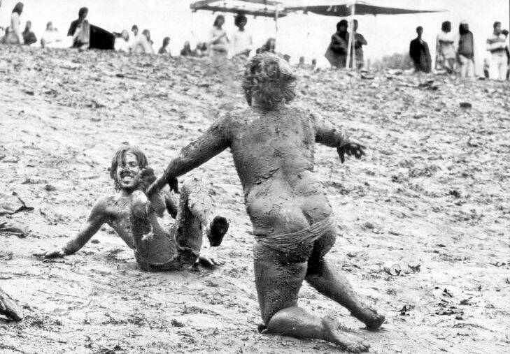 SUNBURY POP FESTIVAL, 1975: Sunbury turned to Mudbury as the rain teemed down. Mudslider John Akers, 18, of Frankston bears down on Brian Carson of Bonbeach during yesterdays festival washout. [Festival dates: 25??????27 January 1975]. 25-01-1975. PICTURE: Fairfax Photographic

SEE ALSO FDC ID No: 121109097

Sunbury Pop Festival, Sunbury Rock Festival, Sunbury Music Festival, Sunbury Festival 1975, Sunbury 1975. Hippies, nudity, naked, audience, crowd. 1970s fashion / 1970s fashions / fashion 1970s.
black and white, black & white, mud, slipping, youth

File pic (Melb): AUST: CULTURE: FESTIVALS: POP: SUNBURY
Date filed: 26-01-1975
Neg no: Sunday Press neg, not held by library [SP 2536 - Pub: 26-1-1975]
ID: mls

[A century of pictures: Book - trends - music].