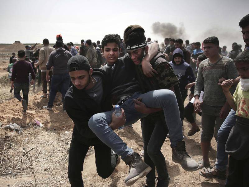 Palestinians have been wounded by Israeli fire during mass protests along Gaza's border with Israel.