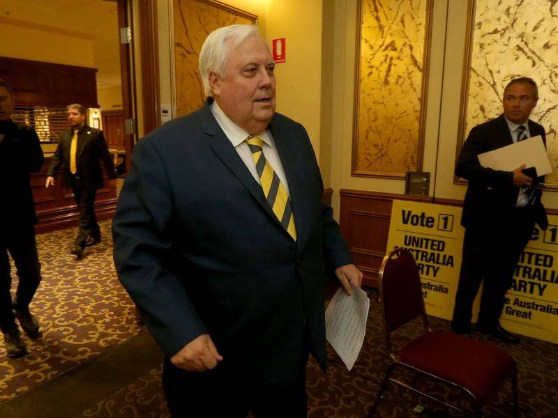 Clive Palmer says he'll addresses the issue of a candidate who posted racist and sexist posts.
