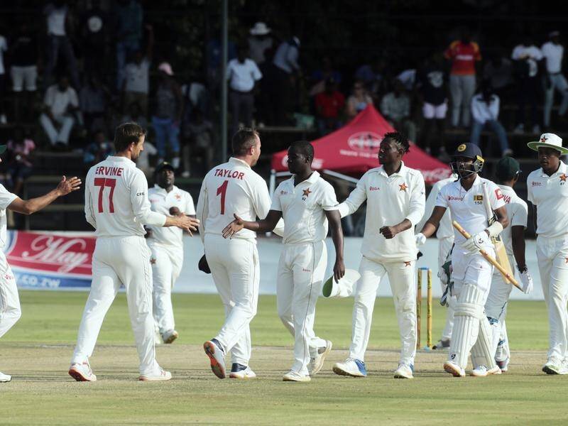Sri Lanka and Zimbabwean players shake hands after the tourists' first-Test victory in Harare.