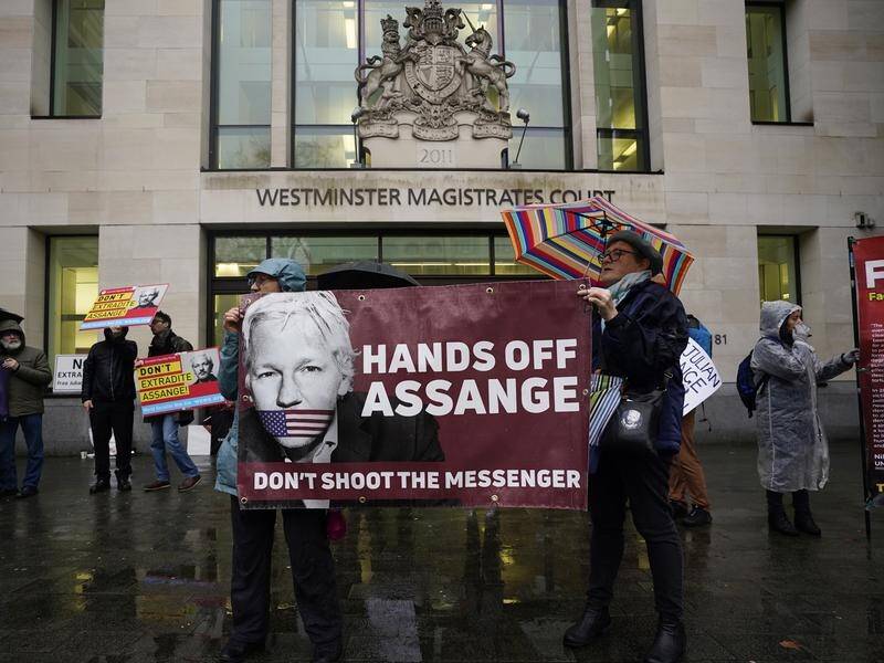 Julian Assange has been questioned about claims a Spanish firm spied on him at the Ecuador embassy.
