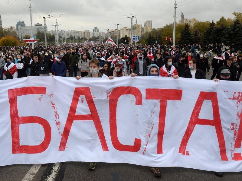 Protesters carrying a banner reading 'Enough' during an anti-government rally in Minsk.