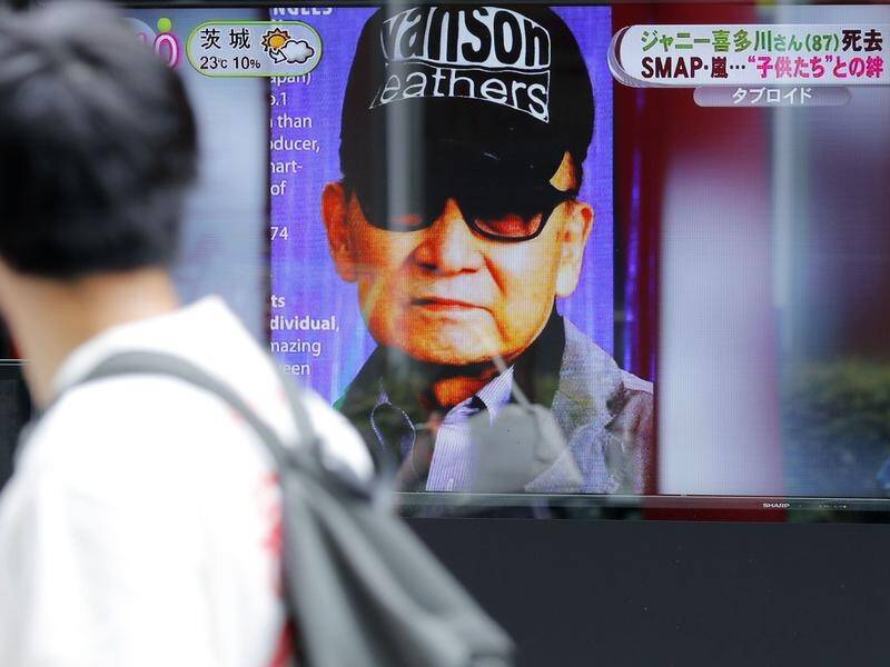 A roadside screen in Tokyo reports on the death of entertainment tycoon Johnny Kitagawa.