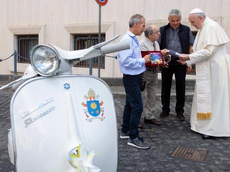 Vespa fans have gifted Pope Francis with a personalised original 50R model and a white helmet.