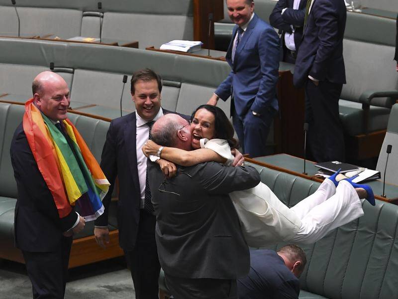 Liberal MP Warren Entsch hugs Labor MP Linda Burney to celebrate the same-sex marriage bill.