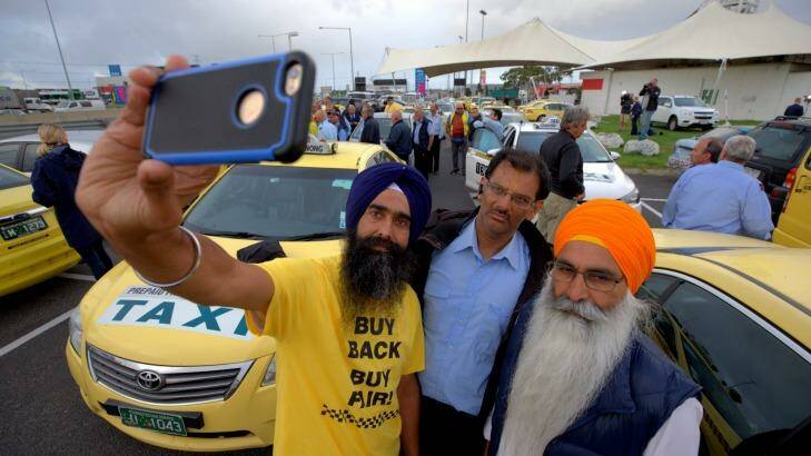 Taxi drivers take a selfie and get angry at the level compensation for licenses. They are taking their protest in both directions to the Bolte Bridge. Photo: Jason South