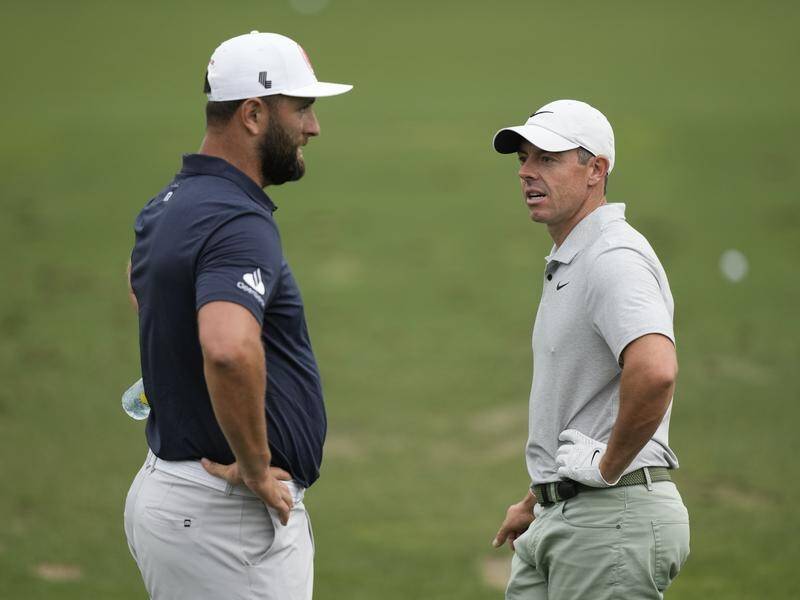 Jon Rahm (left) and Rory McIlroy (right) struggled to make headway at Augusta National. (AP PHOTO)