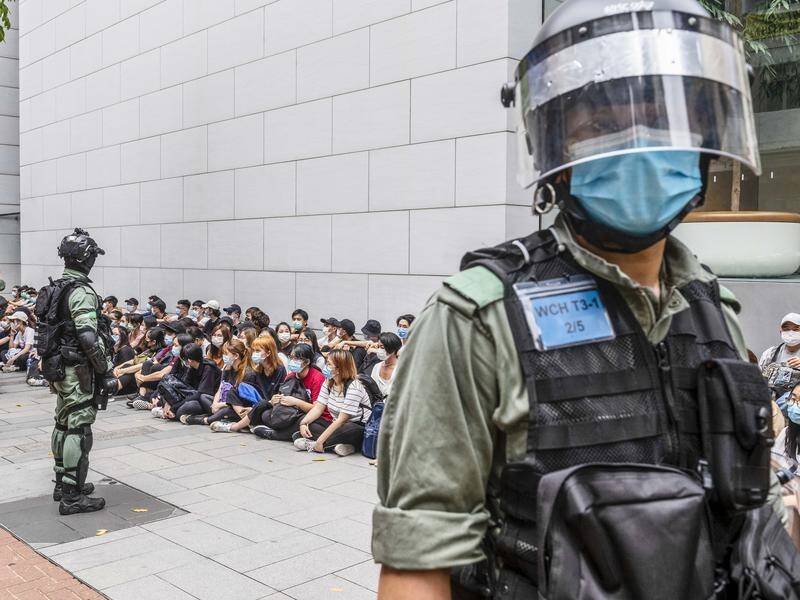 Hong Kong police have made 360 arrests and fired pepper pellets to disperse crowds of protesters.