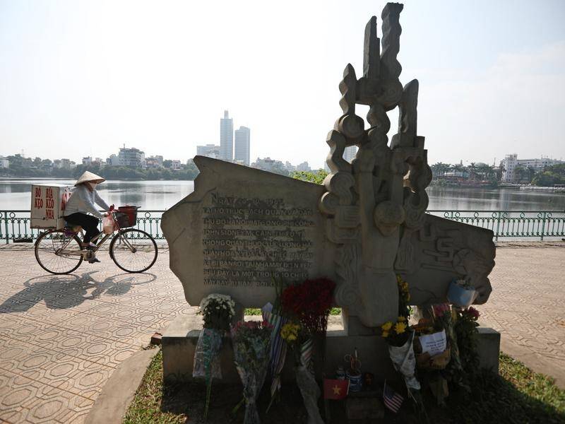 Flower tributes made to US Senator John McCain at a statue in his honour at Truc Bach Lake in Hanoi.