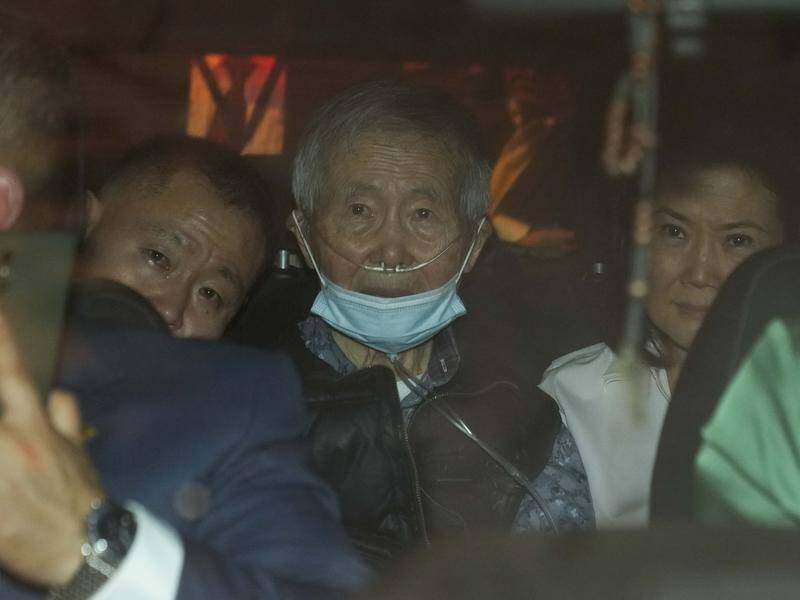 Former Peru president Alberto Fujimori is driven out of prison by his children after being released. (AP PHOTO)
