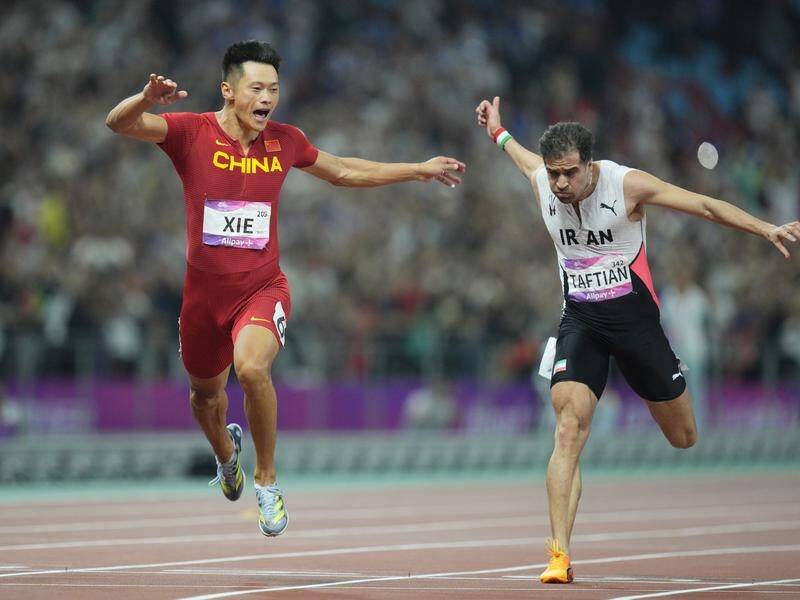 China's Xie Zhenye powers to victory in the 100 metres at the Asian Games in Hangzhou. (AP PHOTO)