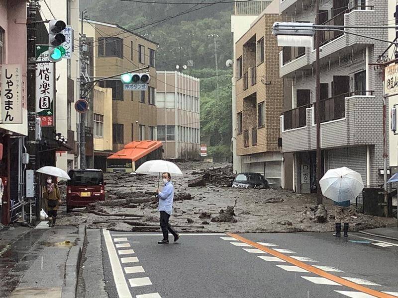 A powerful mudslide in Japan has killed at least two people with some 20 others still missing.
