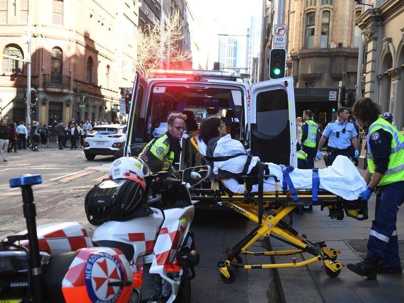 A man was arrested after stabbing a woman and attempting to stab others in Sydney's CBD.