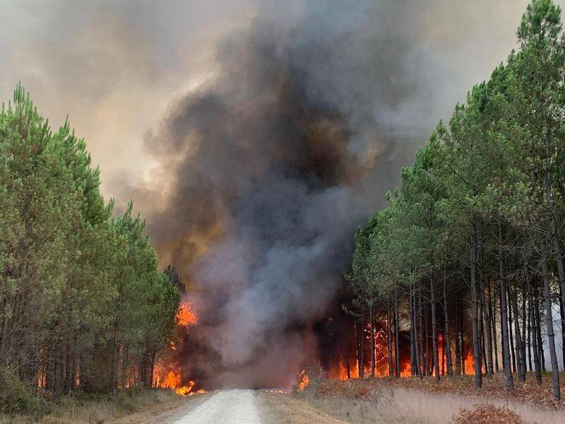 More than 8000 people have been evacuated as firefighters battle wildfire in southwestern France. (AP PHOTO)