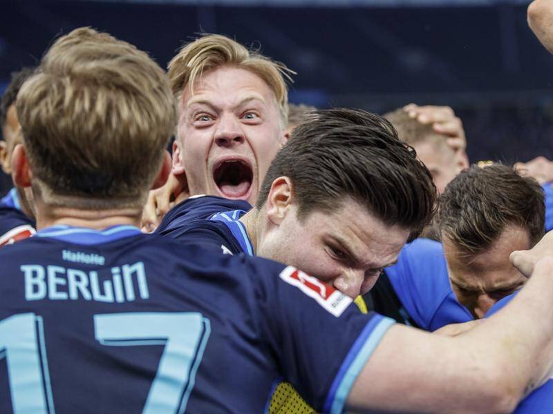 Hertha Berlin players celebrate winning a key clash in the relegation fight with Stuttgart.