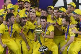 Australian players celebrate with the World Cup after their emphatic win over India in Ahmedabad. (AP PHOTO)