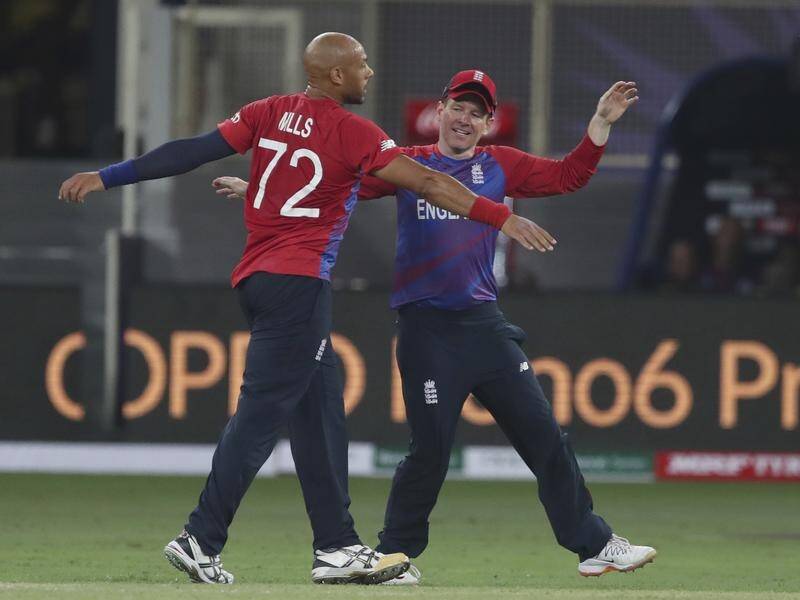 Tymal Mills and Eoin Morgan celebrate the wicket of Chris Gayle in England's comprehensive victory.