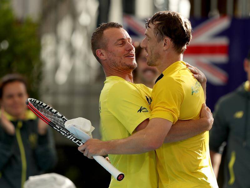 Davis Cup team captain Lleyton Hewitt embraces John Millman after Australia dominated Brazil.