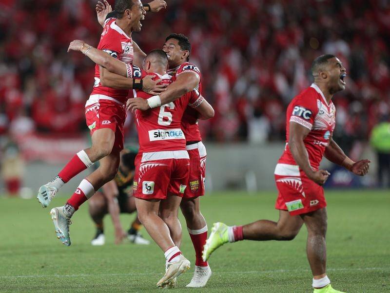 Tongan players celebrate their upset rugby league victory over the Kangaroos.