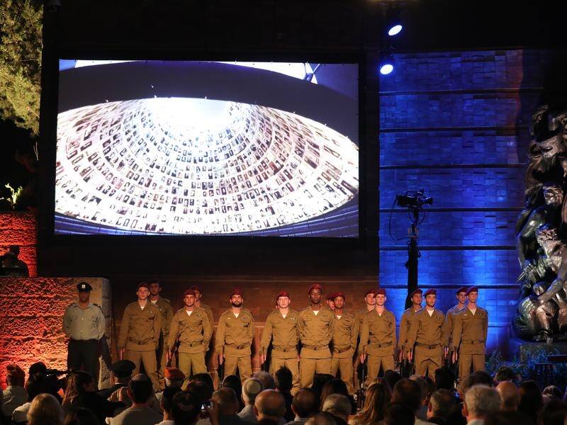 Israeli soldiers show their respect at the annual ceremony at the Holocaust Memorial in Jerusalem.