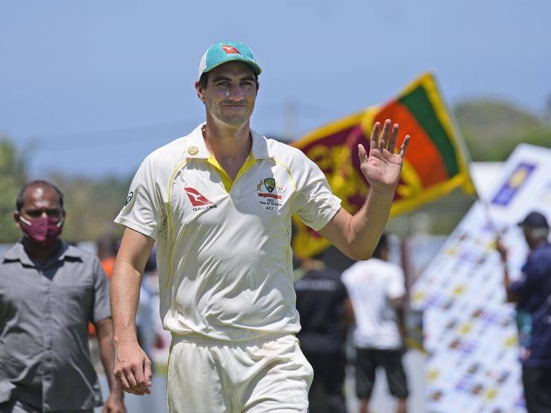 Pat Cummins waves to fans after Australia's swift defeat of Sri Lanka in Galle.
