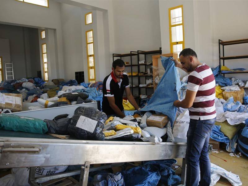 Palestinian postal workers are sorting through eight years of mail that had been held by Israel.