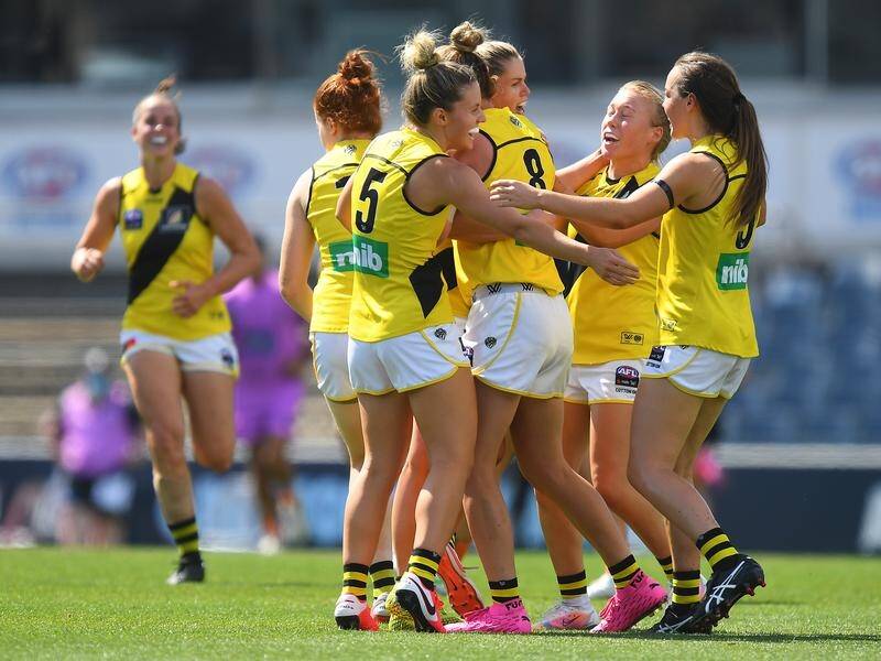 Richmond won their first AFLW match, beating Geelong by 47 points, at the 11th attempt.
