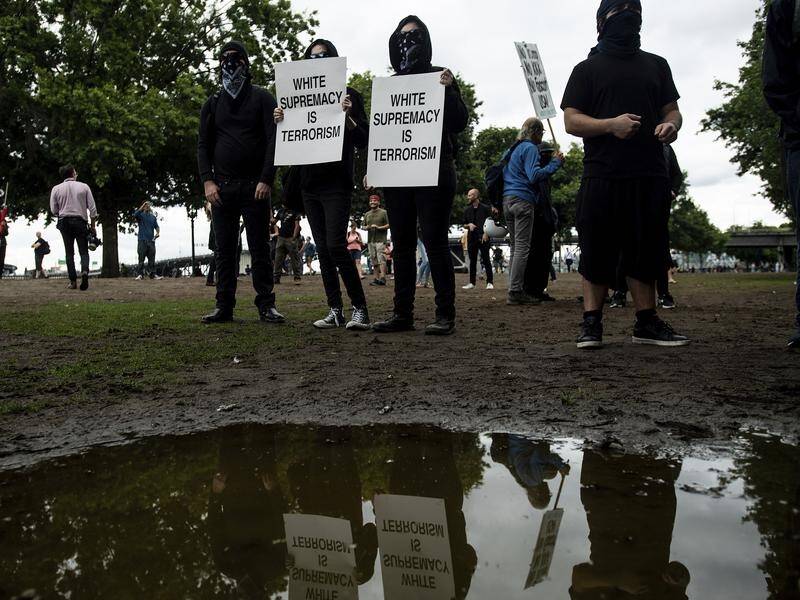 Portland police have seized weapons as far-right groups and counterprotesters gather in the US city.