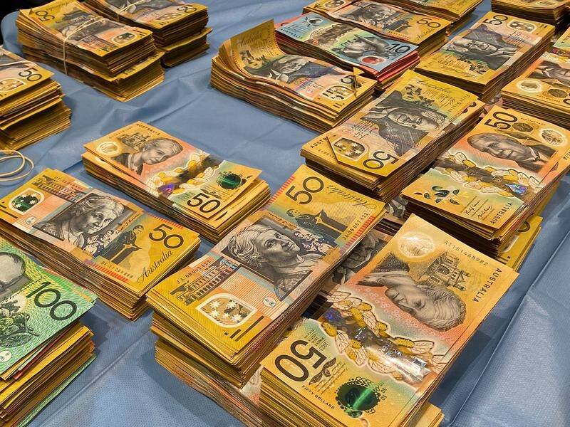 Police have arrested a Sydney man after $1m in cash was allegedly discovered in his home and ute. (PR HANDOUT IMAGE PHOTO)