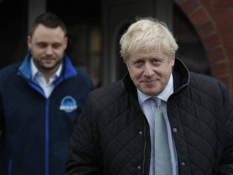 Britain's Prime Minister Boris Johnson (R) has proposed new rules for migrants to the UK.