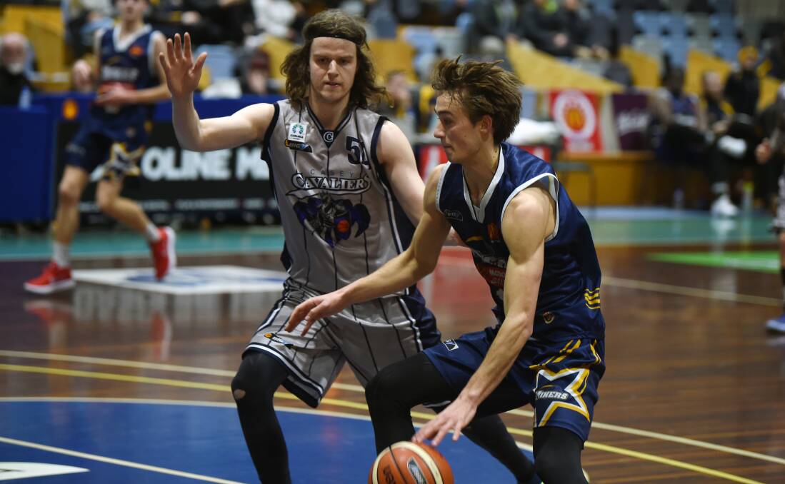 COMPETITIVE: Casey Cavaliers' Alex Bazzucchini and Ballarat Miner Ross Weightman on the floor at the Minerdome on Saturday. Picture: Kate Healy