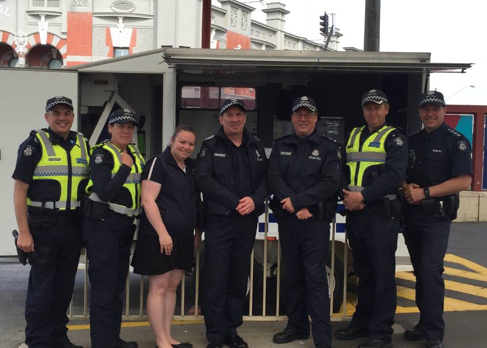 Ballarat Police members outside an information stall set up at the train station.