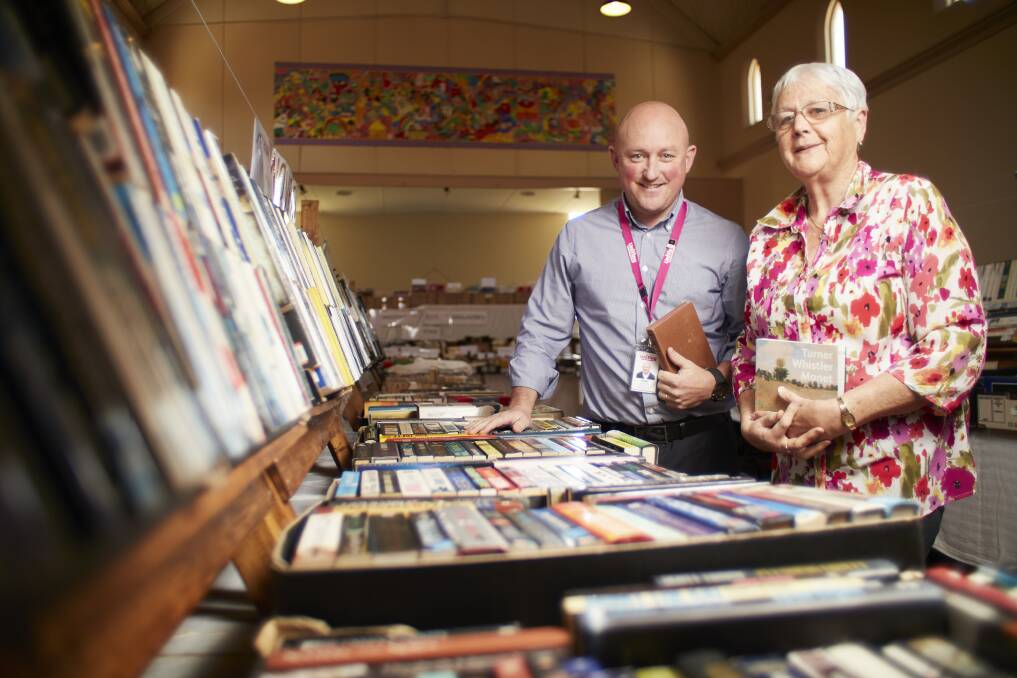 ASSORTMENT: Sean Duffy and Anita Hinton are getting prepared for Uniting Ballarat's book sale at St Andrew's Church Hall this weekend. Picture: Luka Kauzlaric.