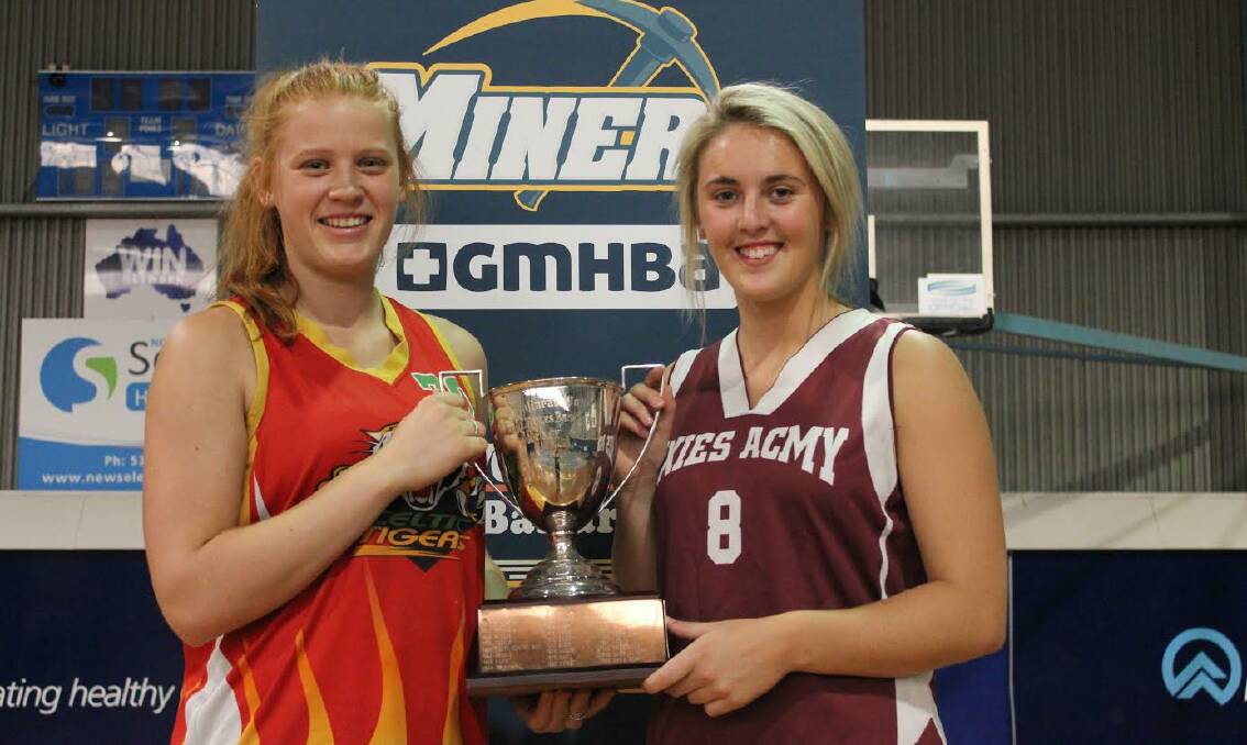 CHAMPIONSHIP TILT: The Celtic Tigers' Ryleigh Haire and Exies Acmy's Jane Douglas with the cup ahead of the women's A grade grand final. 