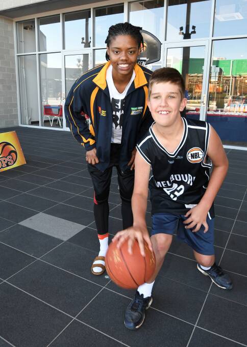 READY TO GO: Courtney Williams with 13-year-old basketball fan Baily Ohlsen. The ambitious import from the United States hopes to one day play in the WNBA. Picture: Lachlan Bence 