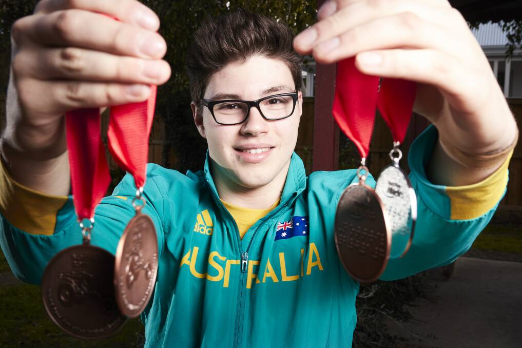 Sam Rizzo with his medals. Picture: Luka Kauzlaric