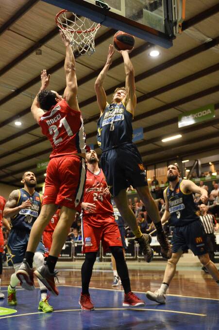 GAME ON: Ballarat Miner Ross Weightman goes up for a shot against Geelong during what was a tough loss for the home team. Picture: Dylan Burns