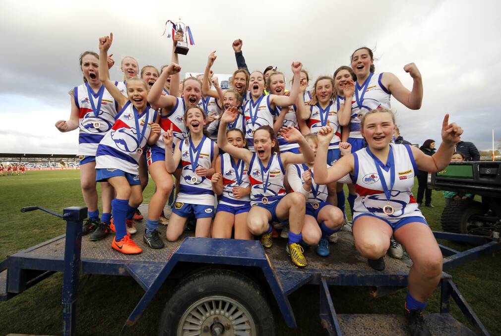 EXCITED: Gisborne White poses for its premiership photo after a win during the Riddell Under-13 Junior Girls grand final over Bacchus Marsh.
