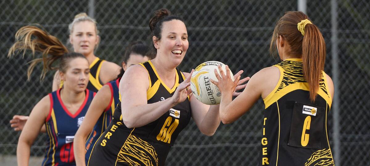 CALL FOR IMPROVEMENT: Player-coach Cynna Kydd of the Tigers receives a pass from centre Kelly Conroy during the scrappy A-grade round seven game. 