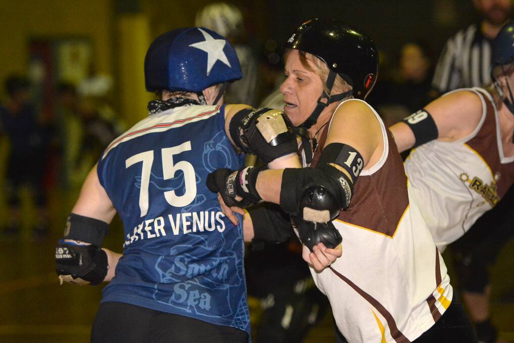 STRENGTH: Beryl Wooding attempts to block jammer Nikita Rigby from the South Sea Roller Derby Sirens in the Rat Pack's home clash on Sunday. Pictures: Dylan Burns