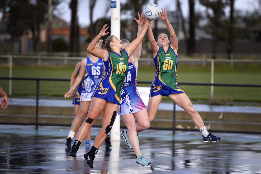WET WEATHER: Molly Boyle of the Lakers, Sunbury Lions' Ruth Smith and Kara Hart of the Lakers compete for the ball. Pictures: Dylan Burns