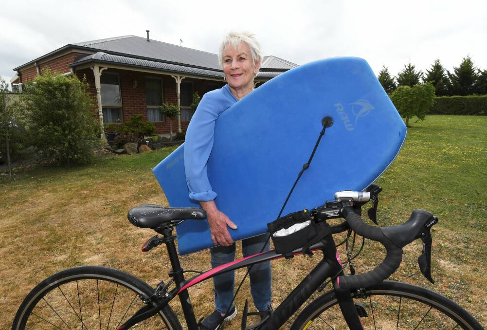 ACTIVE: Jan Farrelly, 75, with her boogie board and bike. Picture: Lachlan Bence 