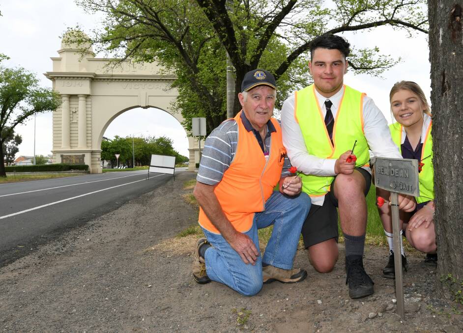 TRIBUTE: Volunteer Len Harwood with Phoenix College year 11 students Nathan Achison and Tahlia Wells before they set off on a massive task of placing poppies along the Avenue of Honour. Picture: Lachlan Bence
