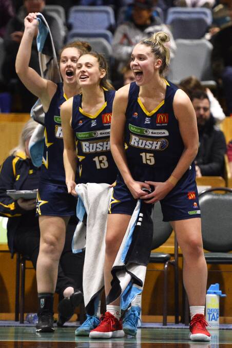 EXCITED: Ballarat Rush's Claire Constable, Taylah Wynne and Molly Mathews cheer on their teammates from the sidelines to a stunning victory. Pictures: Dylan Burns 