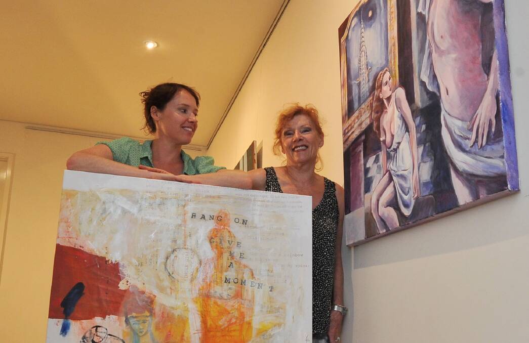 SIGHT FOR SORE EYES: Artists Jade Walsh and Julianne Epstein with their works as they set up for an exhibition at Fairbanks Eye Gallery. Picture: Lachlan Bence 
