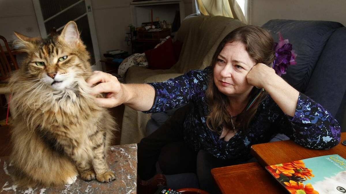 Robyn Charlton of Blackalls park at home with one of her cats, Poppy. Photo: MAX MASON-HUBERS