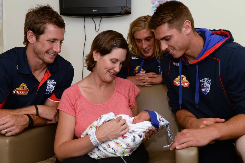 New fan: Dale Morris, Roarke Smith and Michael Talia meet Carly Reynolds and baby Zoe at the St John of God Ballarat Hospital.  PICTURE: Kate Healy. 