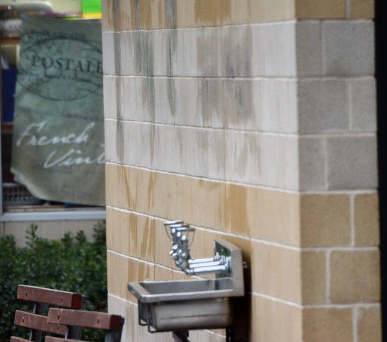 Cleaners worked to remove graffiti at Ballarat Christian College on Monday. PICTURE: KATE HEALY