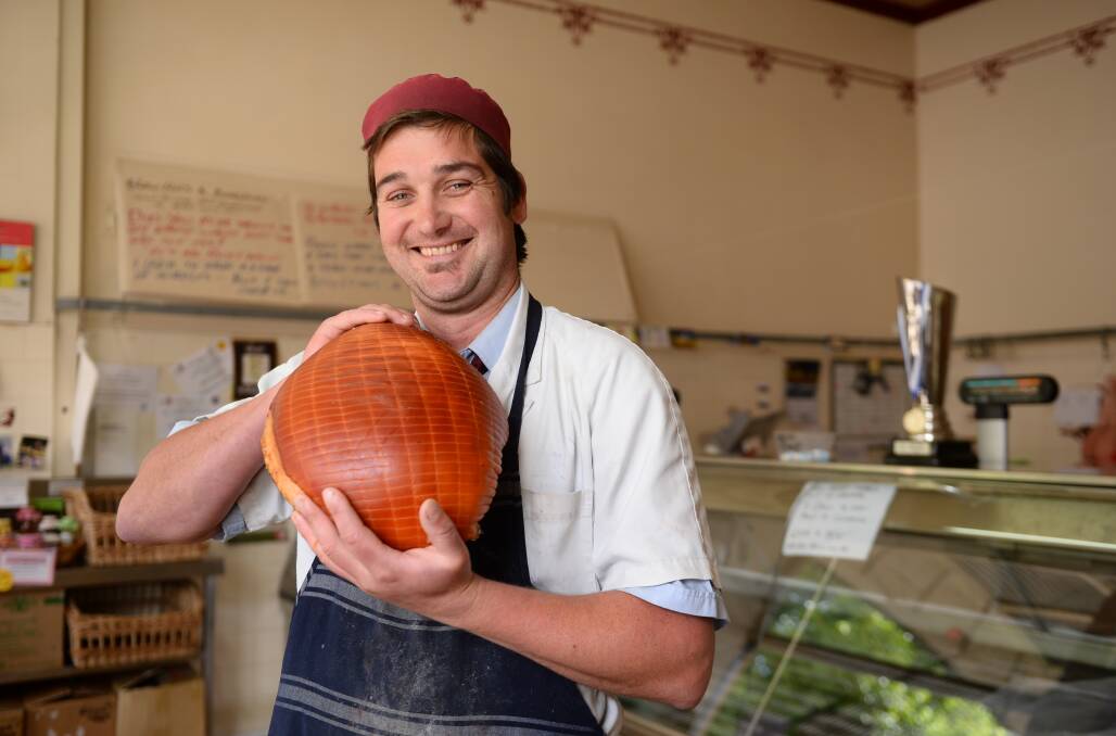 HAM IT UP: John Harbour Quality Butcher manager Matthew Morrish shows off one of the prized hams.